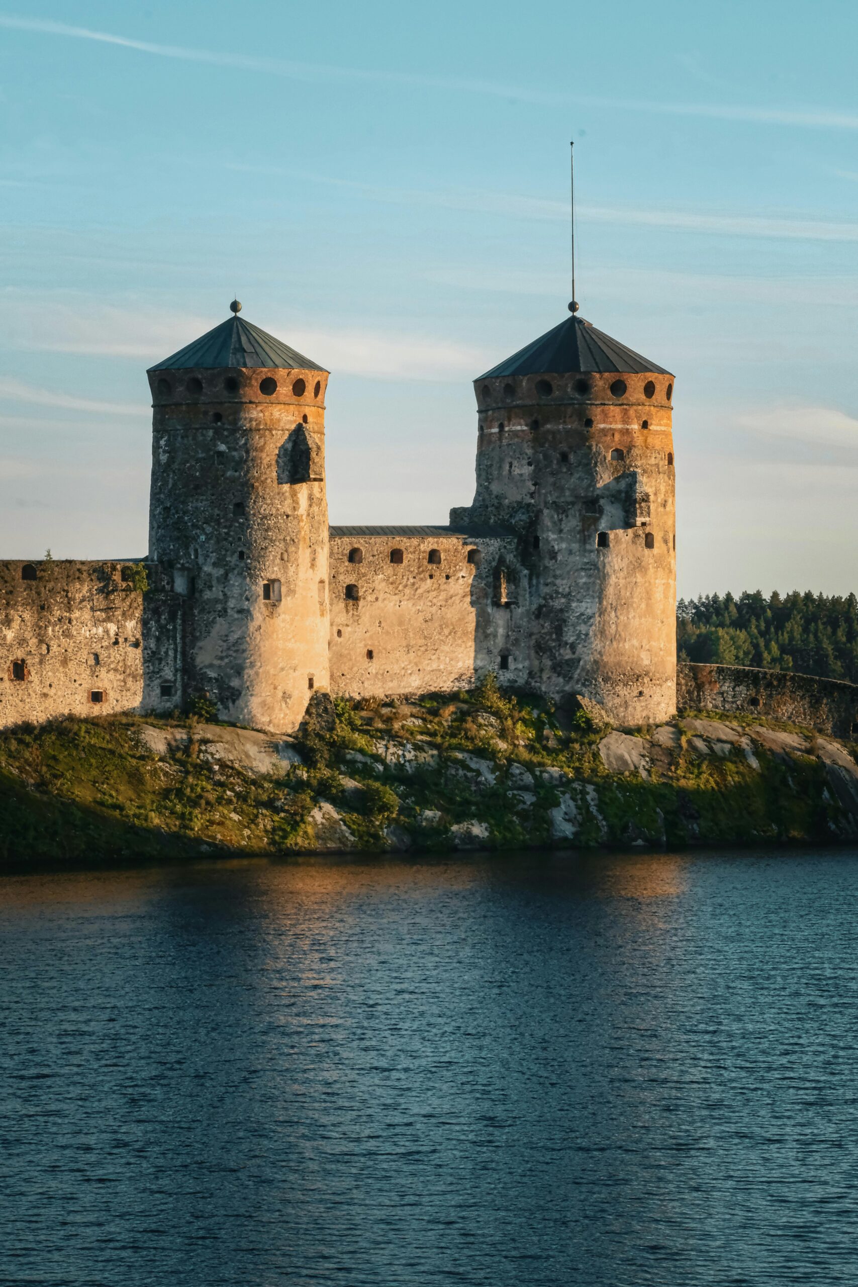 Olavinlinna Castle bathed in warm sunlight, located in picturesque Savonlinna, Finland.